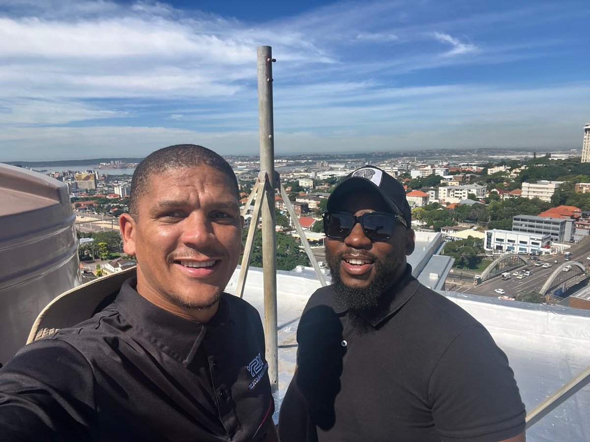 Reign Energy founders on a rooftop site visit overlooking Durban